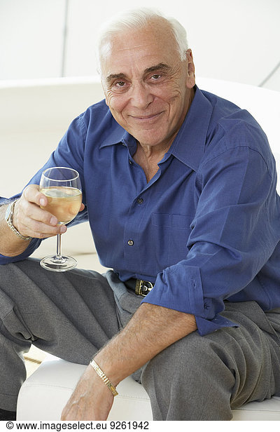 Senior man drinking glass of wine