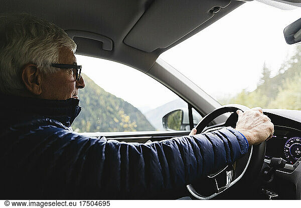 Senior man driving car on weekend