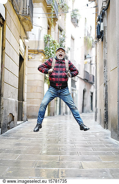 Senior man jumping in the air  Barcelona  Spain