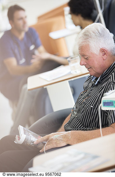 Senior man receiving intravenous infusion in hospital