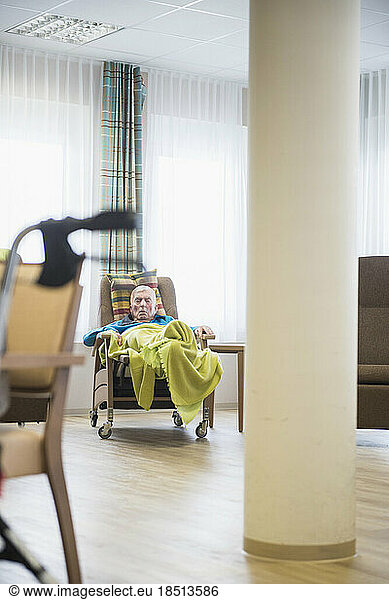 Senior man sleeping in relaxation area at rest home