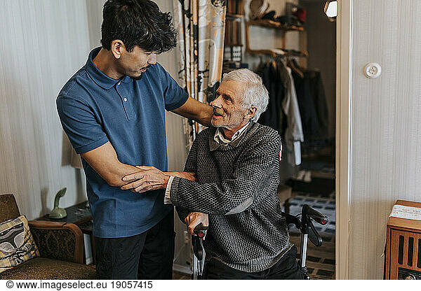 Senior man thanking male healthcare worker at home