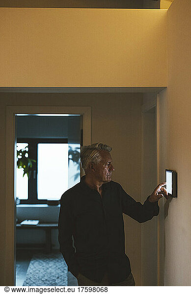 Senior man using tablet PC at smart home