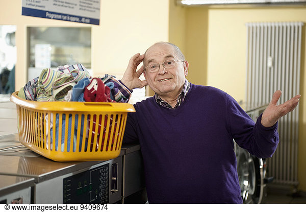Senior man with laundry  smiling