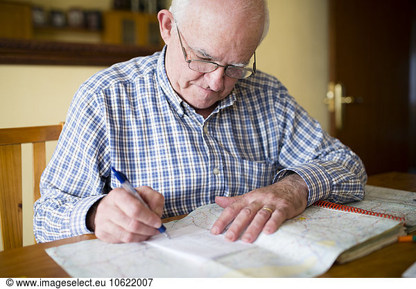 Senior man with road map planning a trip