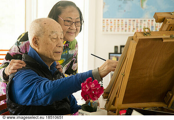 Senior retiree painting in the afternoon