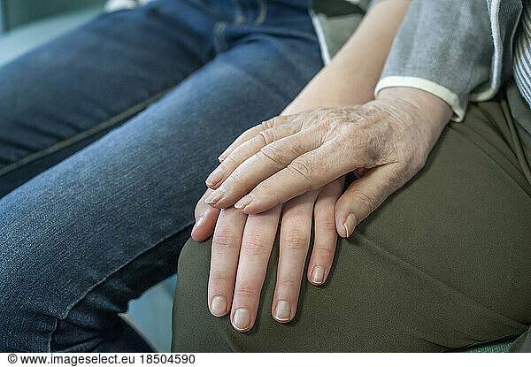 Senior woman holding hand of girl