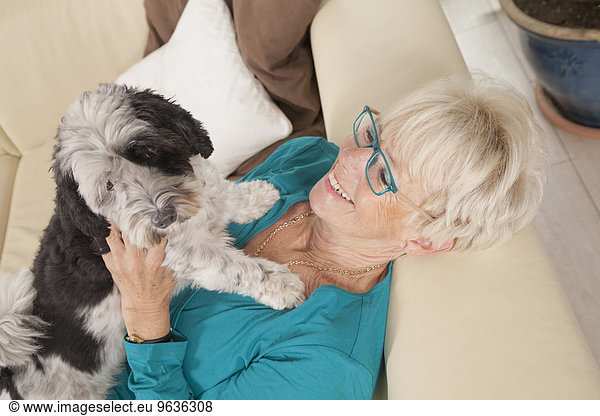 Senior woman playing with her dog