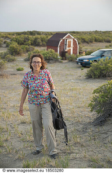 Senior woman poses at campground in desert