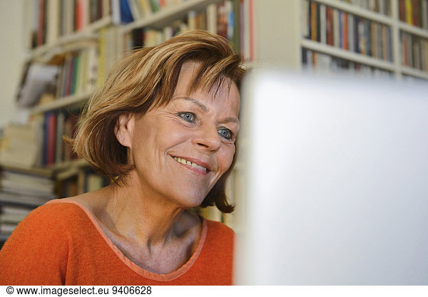Senior woman using laptop  smiling