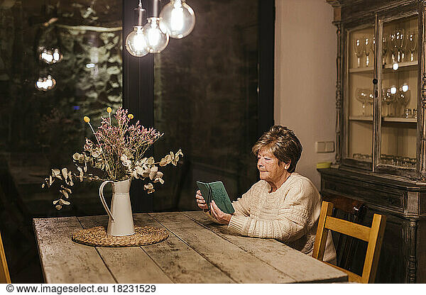 Senior woman using smart phone at home