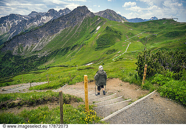 Senior woman walking on steps at Fellhorn and Kanzelwand mountains  Allgau  Bavaria  Oberstdorf  Germany