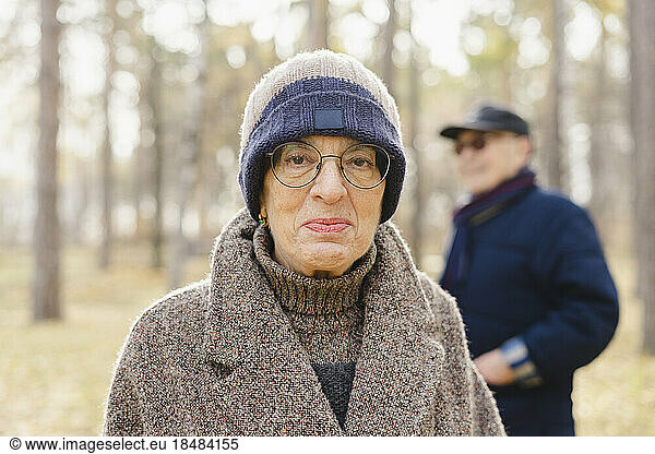 Senior woman wearing eyeglasses and knit hat at park
