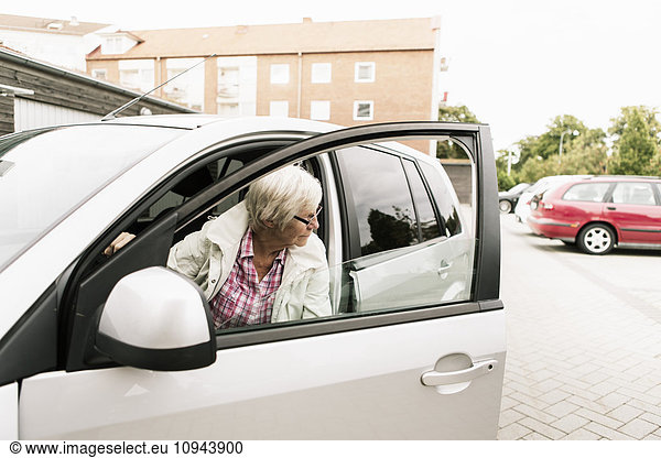 Seniorin im Auto sitzend