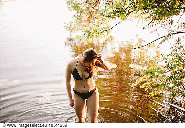 Sensual woman standing in lake
