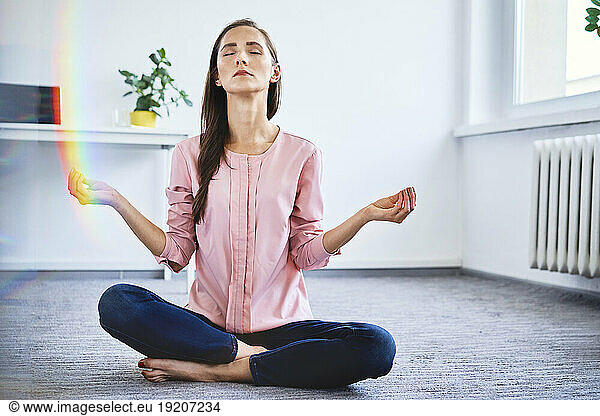 Serene businesswoman meditating in office