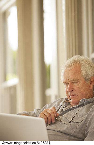 Serious senior man using laptop