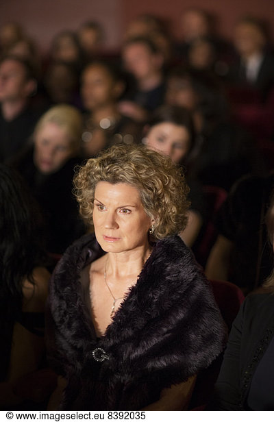 Serious woman in theater audience