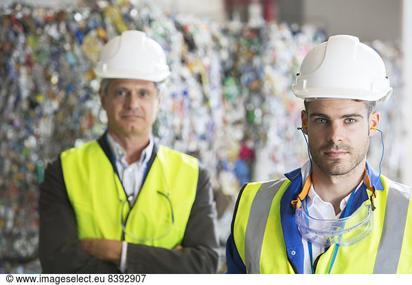 Serious workers in recycling center