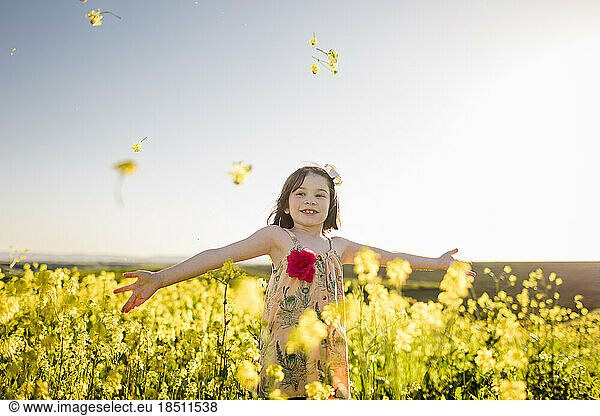 Seven Year Old Girl  Arms Outstretched in Flower Field in San Diego