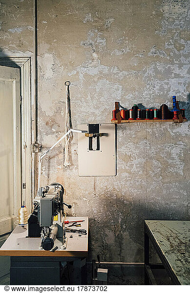 Sewing machine in front of wall workshop