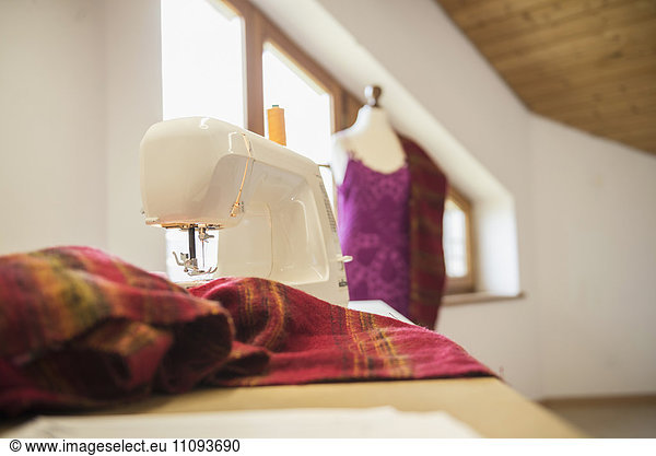 Sewing machine with clothes in clothes shop  Bavaria  Germany