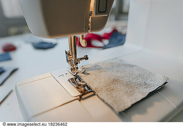 Sewing machine with piece of cloth on table