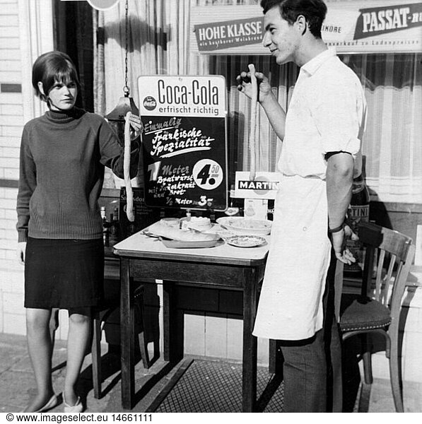 SG hist.  Werbung  GetrÃ¤nke  Coca Cola  Mann und Frau prÃ¤sentieren WÃ¼rste vor einem Schaufenster mit Coca-Cola Werbung  Deutschland  1960er Jahre