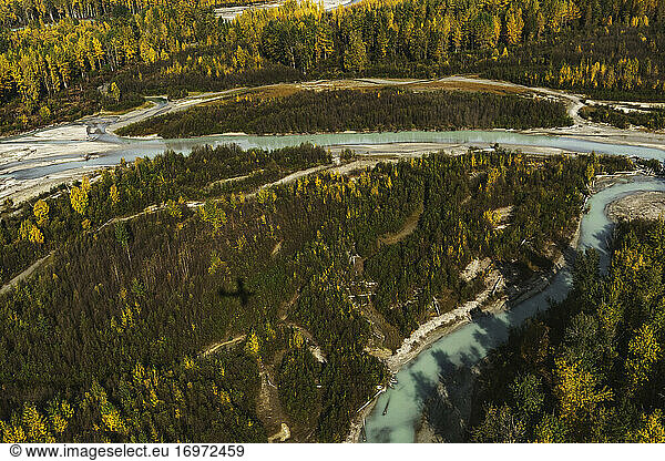 Shadow of an airplane with rivers and fall colors in Alaska