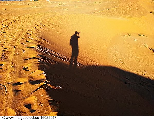 Shadow of photographer in the Merzouga desert