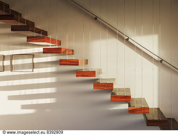 Shadows on floating staircase in modern house