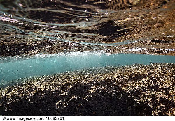 Shallow water and ocean surface above shallow coral Hawaiian reef