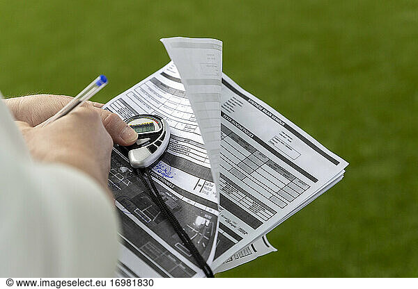 sheet of paper and stopwatch during sports performance analysis
