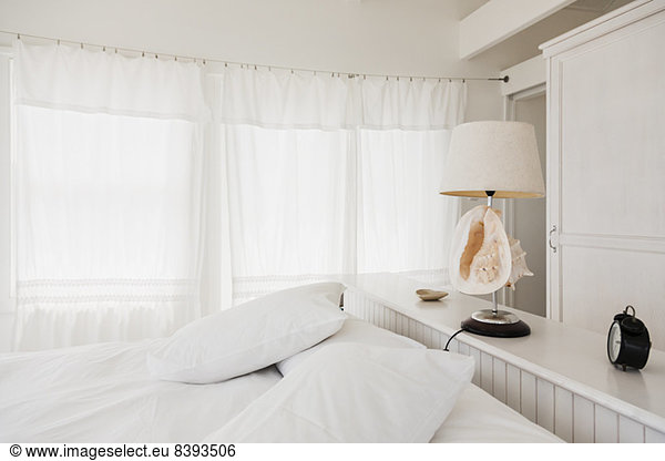 Shell lamp in white bedroom