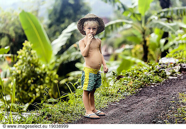 Shirtless boy standing in tropical scenery  Kintamani  Bali  Indonesia