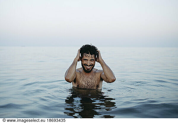 Shirtless happy man enjoying in sea