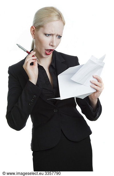 Shocked businesswoman reading letter