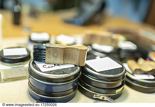 Shoe polishes and brush at workshop
