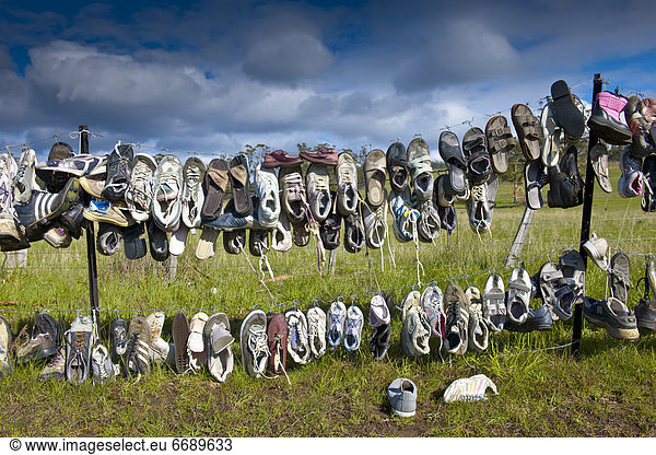 Shoes Hanging on Fence