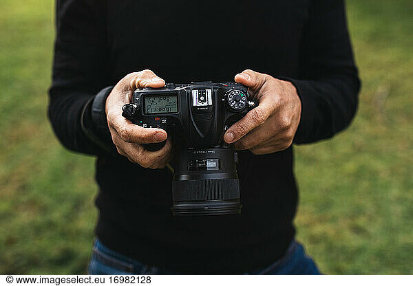 Shot Of A Man's Hands Holding A Camera