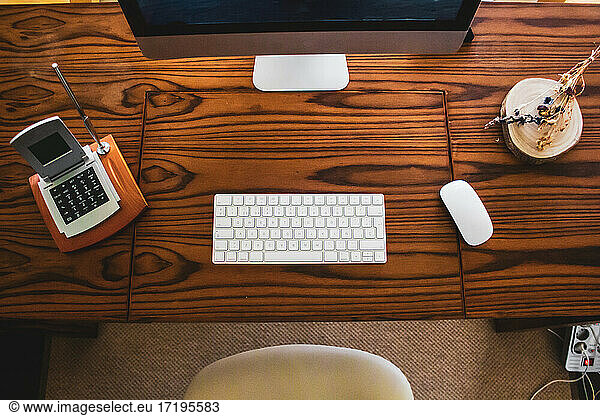 shot of table computer with mouse and keyboard on wooden table