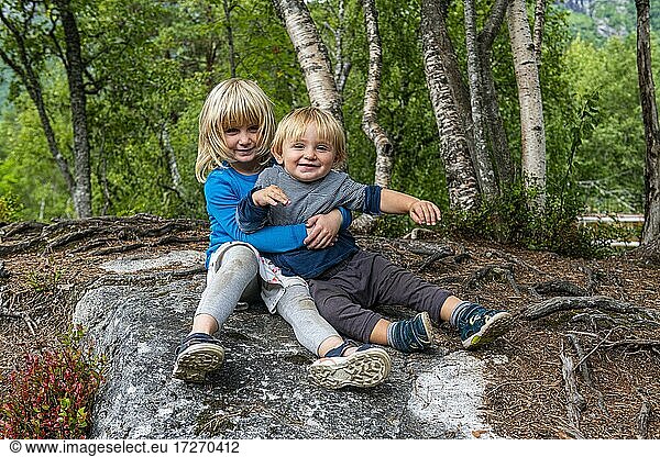 Siblings hugging each other  Gudbrandsjuvet  Trollstigen mountain road  Norway  Europe