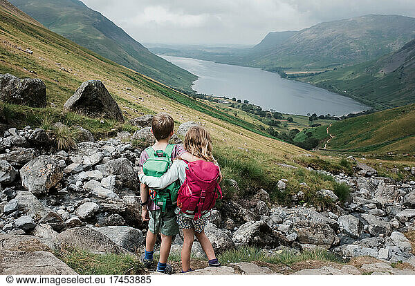 siblings hugging taking in the beautiful view over Scafell Pike