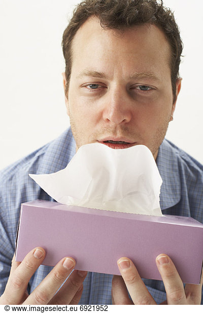 Sick Man Holding Tissue Box