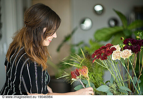 Side profile of woman assembling bouquet
