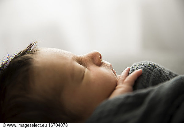 Side Profile View of Sleeping Newborn With Lots of Hair