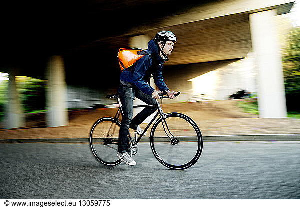 Side view of cyclist riding bicycle