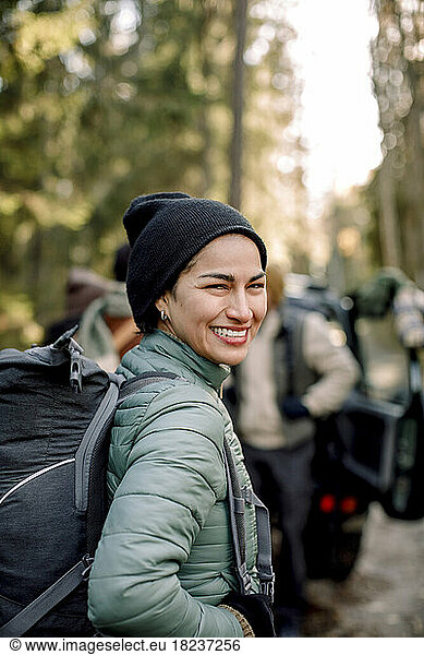 Side view of happy woman with backpack