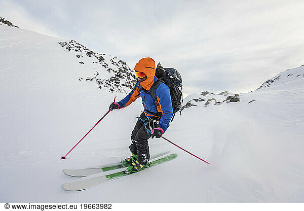 Side view of man moving fast on skis