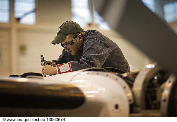 Side view of man working in aerospace industry